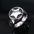 Close-up of vintage stainless steel punk ring featuring a central star relief carving - US 7 / Vintage Steel