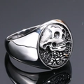 Macro shot of punk style skull and ribcage relief on silver stainless steel ring - US 7 / Steel