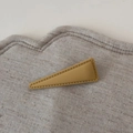 Detailed view of matte khaki triangle hair clip with decorative stitching on linen fabric - Matte Yellow Triangle Clip