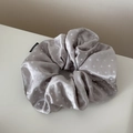 Detail of silver-grey satin scrunchie with white polka dots and fashion label - Apricot