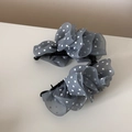 Close-up of grey-blue polka dot mesh banana hair clips with elegant layered ruffles - Gray