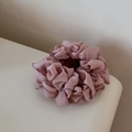 Detail of mauve pleated chiffon scrunchie with ruffled texture and layered flower design - Pink