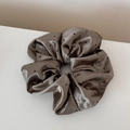 Close-up of brown satin polka dot oversized scrunchie with smooth silk texture - Coffee Polka Dot Glossy Satin - Large Scrunchie