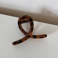 Dettaglio della molletta per capelli leopardata con finitura lucida e molla in metallo - Leopardo Caffè Forma Incrociata