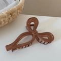 Detailed view of the dark brown translucent ribbon bow hair claw clip with metal spring - Brown