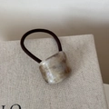 Close-up of handmade tortoiseshell acetate bead on high-elasticity hair tie - Gold Foil Purple