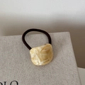 Detail of tortoise shell acetate charm with France Handmade text on elastic hair tie - Beige