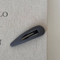 Detail of grey ribbed fabric texture on a water drop shaped hair clip with metal inner - Hollow Water Drop-Grey