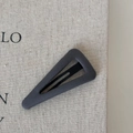 Macro shot of dark grey triangular hair clip showing textured fabric and BB clip mechanism - Hollow Triangle-Grey