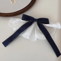 Detail of a denim bow hair clip with white lace trim and vintage brown stitching accents - Denim Bow Skirt Top Clip / Dark Blue