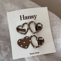 Close-up of heart-shaped hair clips with polka dots and grid patterns on a card - Plaid And Polka Dot Clips / Light Coffee