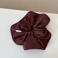 Detail of burgundy textured fabric scrunchie with Hand Made label and ribbed finish - Scrunchie / Burgundy