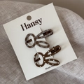 Detailed view of two cute brown rabbit hair clips with polka dots on display card - Light Coffee
