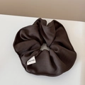 Detail showing deep brown textured scrunchie with a white Hand Made woven label - Scrunchie / Dark Brown