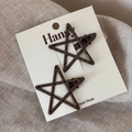 Close-up of brown star hair clips with polka dots and stripes on white card - Dark Brown
