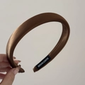 Detail of dark brown satin headband with handmade label and high-gloss silk texture - Brown