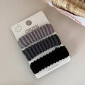 Detailed macro view of three high-elasticity wide ribbed hair ties in grey and black set - Dark Grey