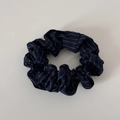 Detailed view of dark blue fabric scrunchie with white vertical stripes and soft pleats - Navy Stripe
