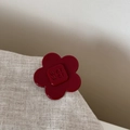 Macro shot of dark red acetate flower hair clip with wer wer embossed letters - Small Flower Style / Red