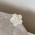 Detailed close-up of cream white acetate flower hair clip with wer wer letter engraving - Small Flower Style / White