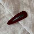 Detailed macro view of burgundy velvet BB hair clip with black metal snapping base - Teardrop / Red