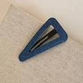 Close-up of blue denim texture and black metal structure on a triangle hair clip - Denim BB-Triangle