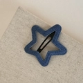 Detail of blue denim star hair clip with black snap closure on textured beige fabric - Denim BB-Five-Pointed Star