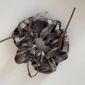 Detail view of ballet-style brown plaid scrunchie with delicate silk ribbon bow accents - Ballet Style Grey Coffee Checkered