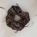 Detailed close-up of brown plaid scrunchie with delicate ribbon bows in ballet style - Ballet Style Coffee Checkered