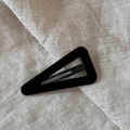 Detailed view of black velvet triangle snap hair clip on a textured linen background - Triangle / Brown