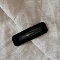 Close-up of a black velvet rectangle snap hair clip showing soft flocked texture details - Rectangle / Black