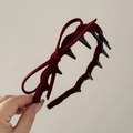 Macro view of burgundy velvet headband featuring a side bow and long non-slip inner teeth - Red