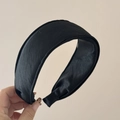 Detailansicht des dicken schwarzen Satin-Stirnbands mit breitem, gepolstertem Design und Textur - Schwarz