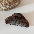 Detail of tortoiseshell acetate hair claw clip with gold Barrette La France lettering - Blue-Coffee Marble