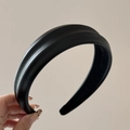 Close-up of black PU leather puffy headband showing premium textured grain and stitching - Black