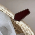 Detailed macro view of woven straw basket texture with burgundy leather logo patch - Pentagon Shape / Red