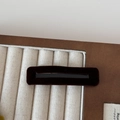 Detail view of the brown velvet rectangular hair clip with a stylish black hollow center design - Brown