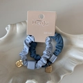 Detail of high-elasticity blue scrunchies with square bead and gold charm on card - Blue