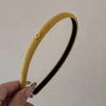 Detail showing the yellow fabric headband texture with a golden Love engraved metal plate - Yellow