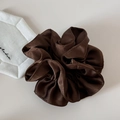 Detailed view of large brown satin hair scrunchie with elegant glossy pleated texture - Brown