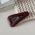 Detailed close-up of dark red leather triangle hair clip on a soft white knit background - Hollow Leather Triangle BB-Red