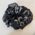 Close-up of leopard print chiffon hair scrunchie with soft pleated texture and semi-sheer fabric - Gray Leopard Print Black Organza Scrunchie