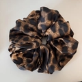 Detailed view of the smooth leopard print satin texture and silk-like fabric folds - Coffee Leopard Print Large Scrunchie