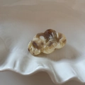 Close-up of cloud-shaped acetate hair clip with brown marble pattern in white tray - Cloud Shape / Acetate Flower Clip - Beige Apricot