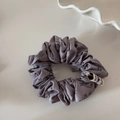 Detailed macro view of French grey-purple scrunchie with leaf print and fabric tag - Grey Purple Series-Purple Scrunchie