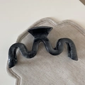 Macro detail of wave shaped marble pattern hair claw clip on soft textured background - Grey Marble M-Shape