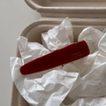 Close-up of deep red acetate hair clip with gold France Handmade logo in a gift box - Red