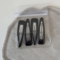 Detail view of 4-pack black metal drop-shaped snap hair clips in clear polybag - Set of 4 / Triangle Black (FJ892956)