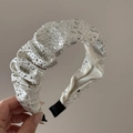Detail of a beige velvet headband featuring heavy rhinestone embellishments and pleats - Beige Satin Rhinestone Headband