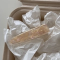 Detailed close-up of acetate duckbill hair clip with marble texture and handmade lettering - Clear White